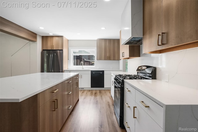 22222 Evergreen St, Macomb, MI 48082 - kitchen with custom range hood, black appliances, modern cabinets, light wood-style flooring, and light stone counters