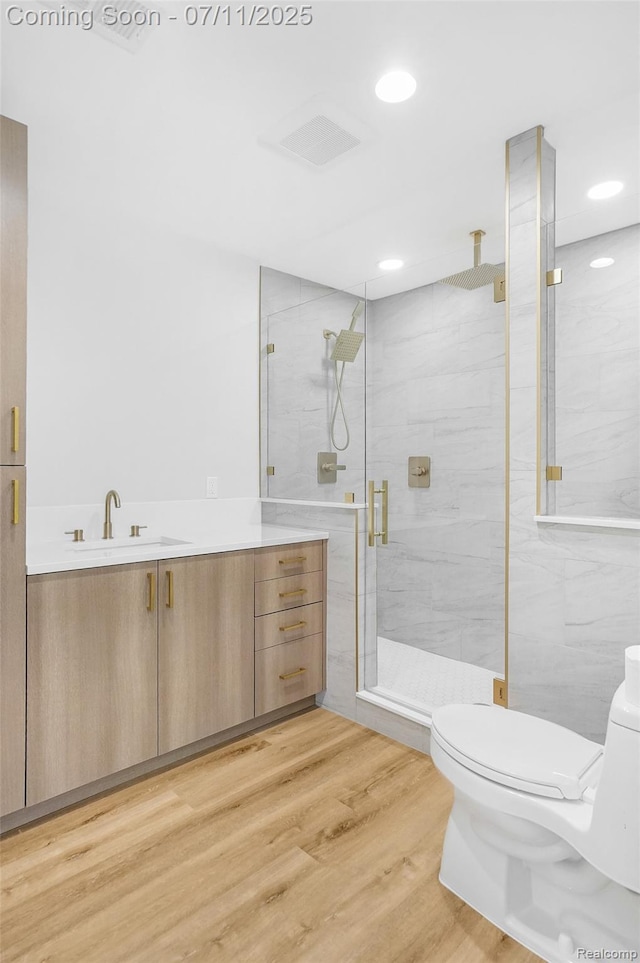 22222 Evergreen St, Macomb, MI 48082 - full bathroom featuring vanity, a marble finish shower, wood finished floors, and recessed lighting