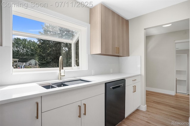 22222 Evergreen St, Macomb, MI 48082 - kitchen featuring dishwashing machine, light countertops, light wood-style flooring, and white cabinets