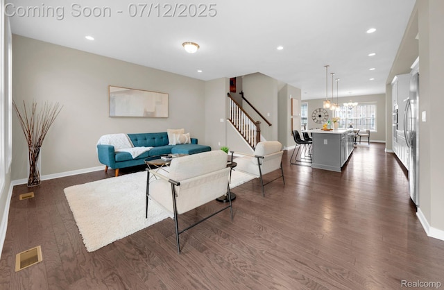2825 Ridington Rd, Ann Arbor, MI 48105 - living area featuring dark wood-style floors, stairs, recessed lighting, and a chandelier