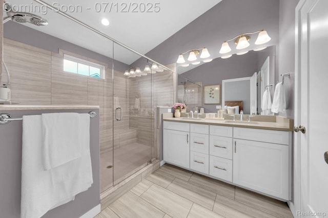 2825 Ridington Rd, Ann Arbor, MI 48105 - bathroom featuring double vanity, a stall shower, and vaulted ceiling