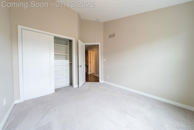 2825 Ridington Rd, Ann Arbor, MI 48105 - unfurnished bedroom featuring carpet, a closet, and high vaulted ceiling