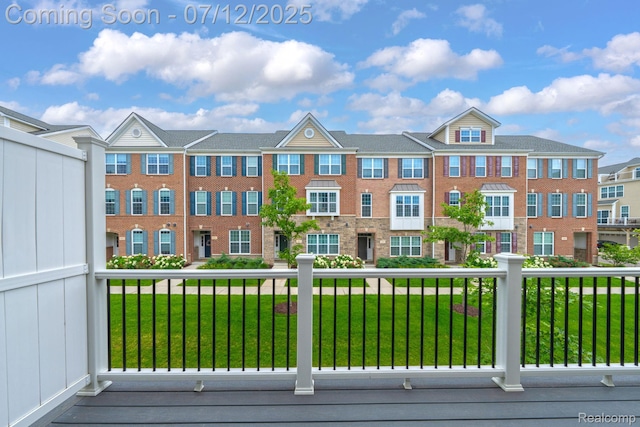 2825 Ridington Rd, Ann Arbor, MI 48105 - view of front of home with a front lawn, a balcony, and brick siding