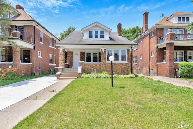 2651 Lakewood St, Detroit, MI 48215 - bungalow with a front yard, brick siding, a chimney, and a shingled roof