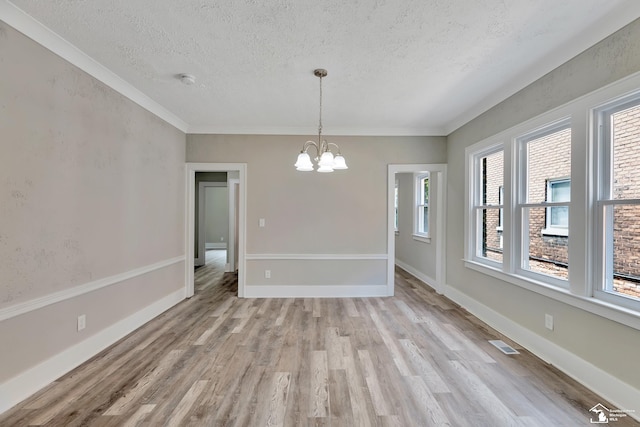 2651 Lakewood St, Detroit, MI 48215 - unfurnished dining area with a textured ceiling, light wood finished floors, a chandelier, and ornamental molding