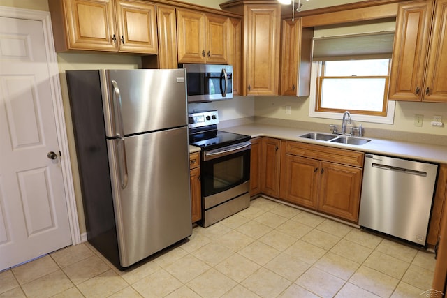 11731 Birch Run Rd, Birch Run, MI 48415 - kitchen with stainless steel appliances, light countertops, light tile patterned flooring, and brown cabinets