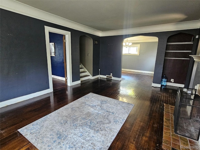 607 Roome Ct, Flint, MI 48503 - empty room with arched walkways, hardwood / wood-style floors, crown molding, stairs, and a chandelier