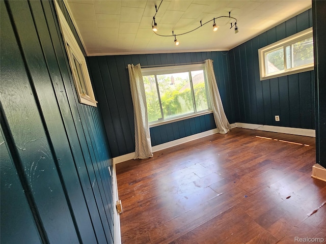 607 Roome Ct, Flint, MI 48503 - unfurnished room with track lighting, dark wood finished floors, and wooden walls