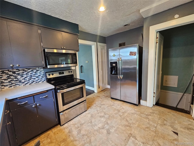 607 Roome Ct, Flint, MI 48503 - kitchen featuring appliances with stainless steel finishes, light countertops, backsplash, and a textured ceiling