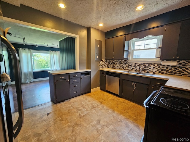 607 Roome Ct, Flint, MI 48503 - kitchen featuring stainless steel dishwasher, light countertops, and backsplash