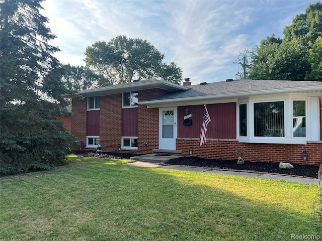 33158 Shawnee St, Westland, MI 48185 - tri-level home with a front yard, brick siding, and a chimney