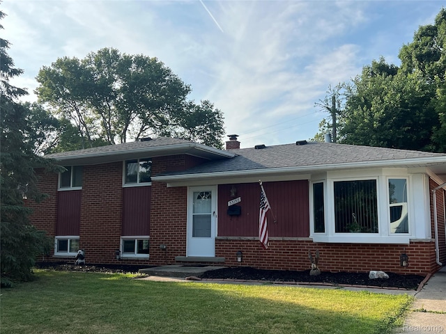 33158 Shawnee St, Westland, MI 48185 - split level home with brick siding, a front lawn, a chimney, and a shingled roof