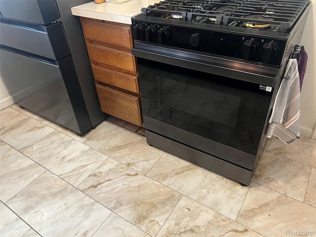 33158 Shawnee St, Westland, MI 48185 - kitchen view of black gas range oven, freestanding refrigerator, light countertops, and brown cabinetry