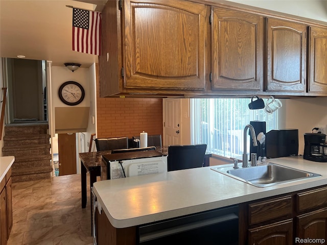 33158 Shawnee St, Westland, MI 48185 - kitchen with light countertops, dishwashing machine, a peninsula, and brown cabinetry