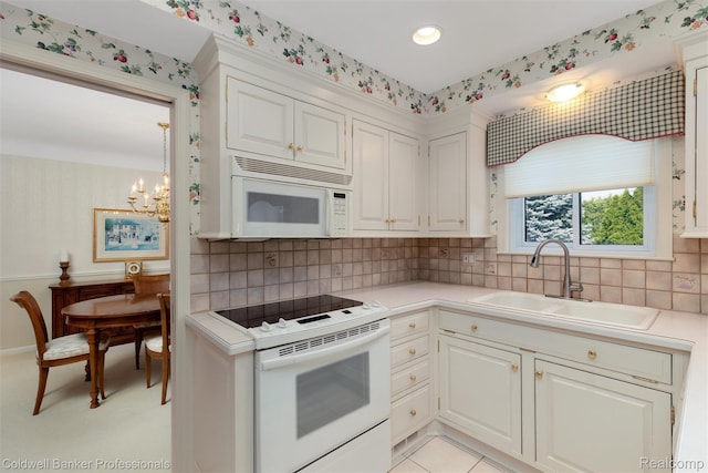 21600 Eastbrook Ct, Grosse Pointe Woods, MI 48236 - kitchen featuring white appliances, light countertops, wallpapered walls, a chandelier, and white cabinetry