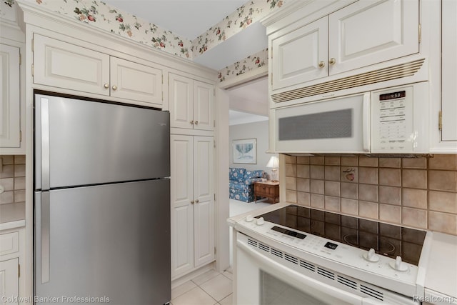 21600 Eastbrook Ct, Grosse Pointe Woods, MI 48236 - kitchen with white appliances, decorative backsplash, light countertops, white cabinets, and light tile patterned flooring
