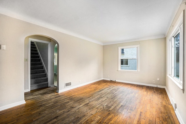 932 Parker Ave, Kalamazoo, MI 49008 - unfurnished room featuring dark wood-style floors, stairs, and arched walkways