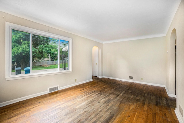 932 Parker Ave, Kalamazoo, MI 49008 - empty room featuring arched walkways and hardwood / wood-style flooring