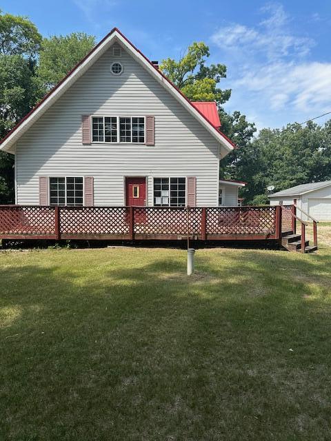 1675 E 8th St, White Cloud, MI 49349 - back of house with a yard and a metal roof