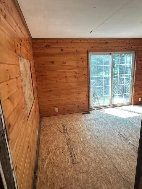 1675 E 8th St, White Cloud, MI 49349 - spare room featuring wooden walls