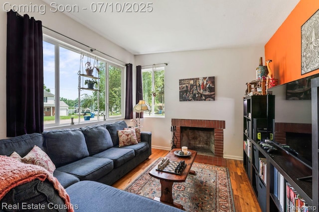 135 Bevins St, Holly, MI 48442 - living room featuring a fireplace and wood finished floors