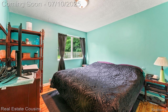 135 Bevins St, Holly, MI 48442 - bedroom with a textured ceiling and wood finished floors