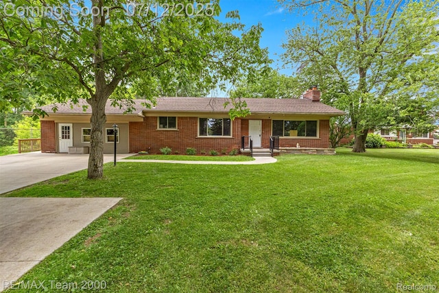 27055 Ann Arbor Trl, Dearborn Heights, MI 48127 - ranch-style home with a chimney, driveway, brick siding, and a front lawn