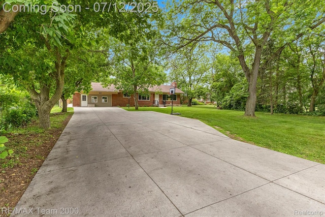 27055 Ann Arbor Trl, Dearborn Heights, MI 48127 - ranch-style house with concrete driveway, a front yard, and brick siding