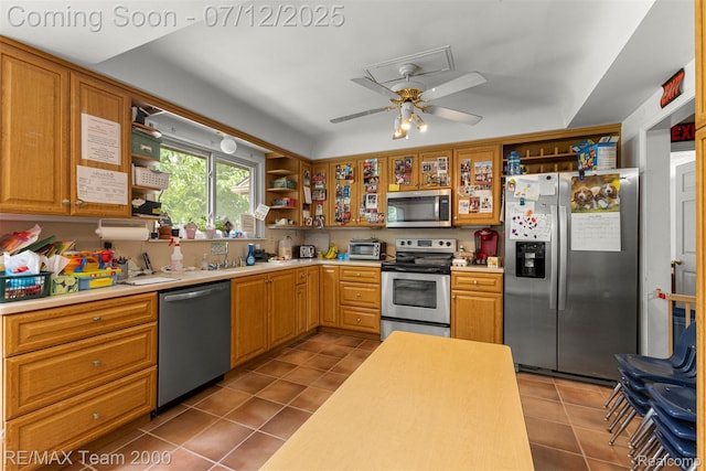 27055 Ann Arbor Trl, Dearborn Heights, MI 48127 - kitchen featuring stainless steel appliances, open shelves, dark tile patterned floors, and light countertops