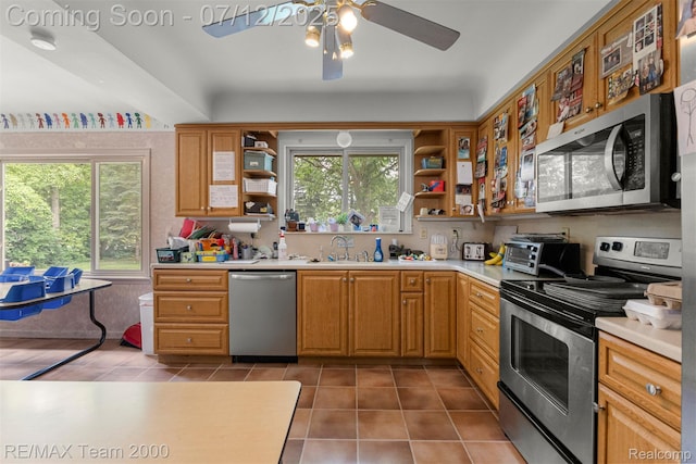 27055 Ann Arbor Trl, Dearborn Heights, MI 48127 - kitchen featuring appliances with stainless steel finishes, open shelves, light countertops, tile patterned floors, and a ceiling fan