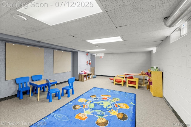 27055 Ann Arbor Trl, Dearborn Heights, MI 48127 - recreation room featuring concrete block wall and a paneled ceiling
