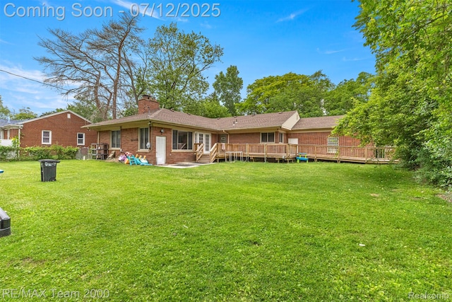27055 Ann Arbor Trl, Dearborn Heights, MI 48127 - back of property featuring brick siding, a chimney, a lawn, and a deck