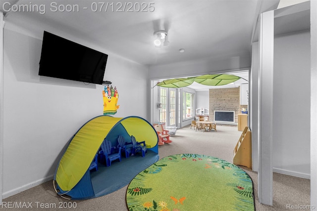 27055 Ann Arbor Trl, Dearborn Heights, MI 48127 - rec room with carpet floors and a fireplace