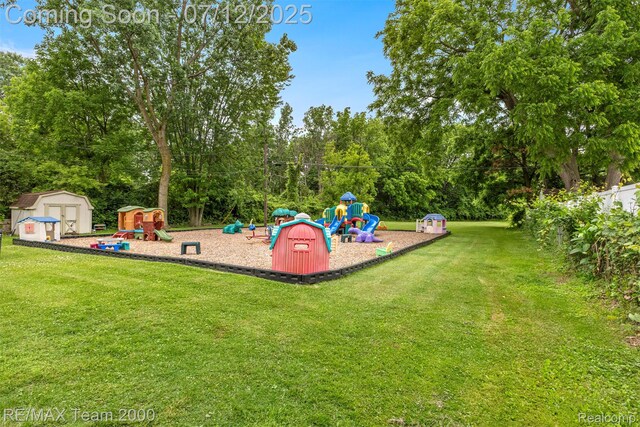 27055 Ann Arbor Trl, Dearborn Heights, MI 48127 - community play area featuring a storage shed, a yard, and view of wooded area