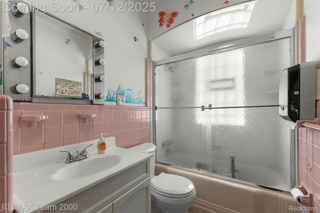 27055 Ann Arbor Trl, Dearborn Heights, MI 48127 - full bathroom with tile walls, vanity, bath / shower combo with glass door, and a wainscoted wall