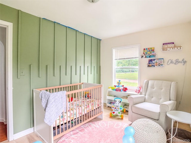1454 Stephens Ave, Flint, MI 48507 - bedroom with a crib and wood finished floors