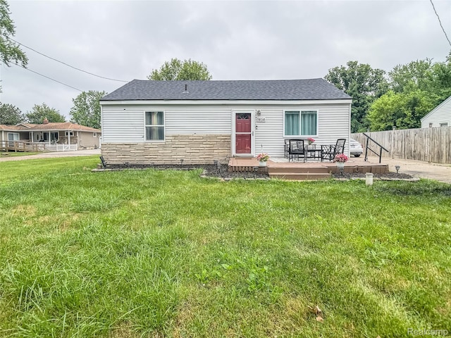 1454 Stephens Ave, Flint, MI 48507 - view of front of property with a deck, stone siding, and roof with shingles