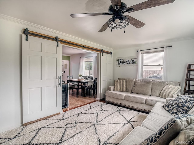 1454 Stephens Ave, Flint, MI 48507 - living room featuring a barn door, crown molding, and a ceiling fan
