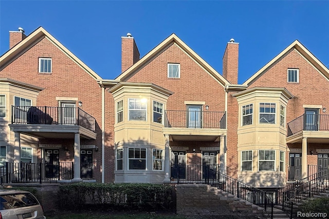 41666 Tera Ln, Novi, MI 48375 - rear view of house featuring a chimney and brick siding