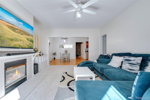 41666 Tera Ln, Novi, MI 48375 - living area featuring a ceiling fan, a fireplace, and light colored carpet