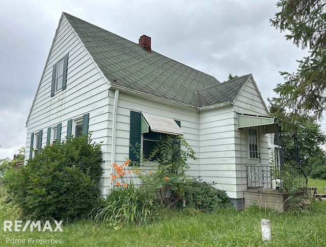 1615 Pound Dr, Flint, MI 48532 - view of property exterior with a chimney and a shingled roof