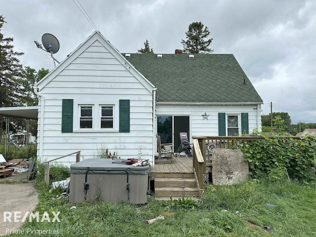 1615 Pound Dr, Flint, MI 48532 - back of property with a hot tub, a wooden deck, and a shingled roof