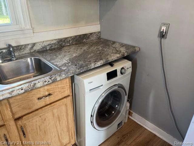 2117 E Buder Ave, Flint, MI 48529 - washroom featuring washer / dryer, wood finished floors, and cabinet space