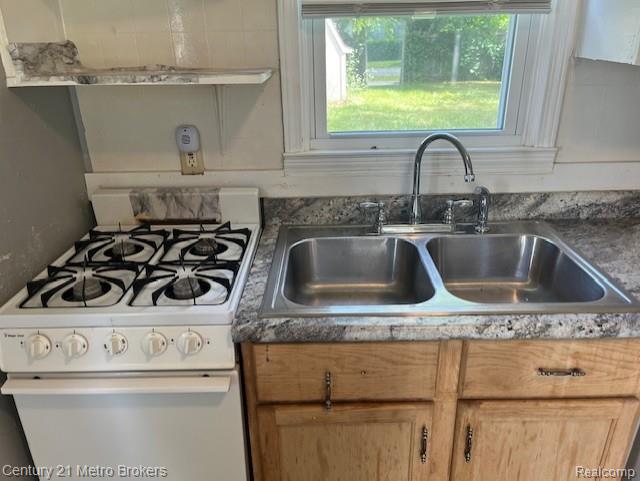2117 E Buder Ave, Flint, MI 48529 - kitchen featuring a sink and white gas range