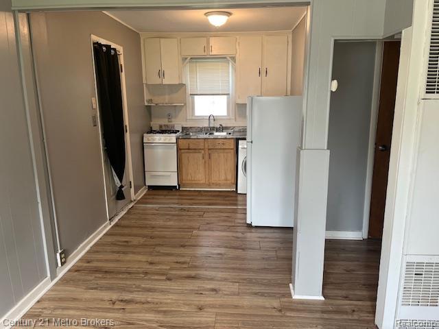 2117 E Buder Ave, Flint, MI 48529 - kitchen with white appliances, dark wood finished floors, and washer / clothes dryer
