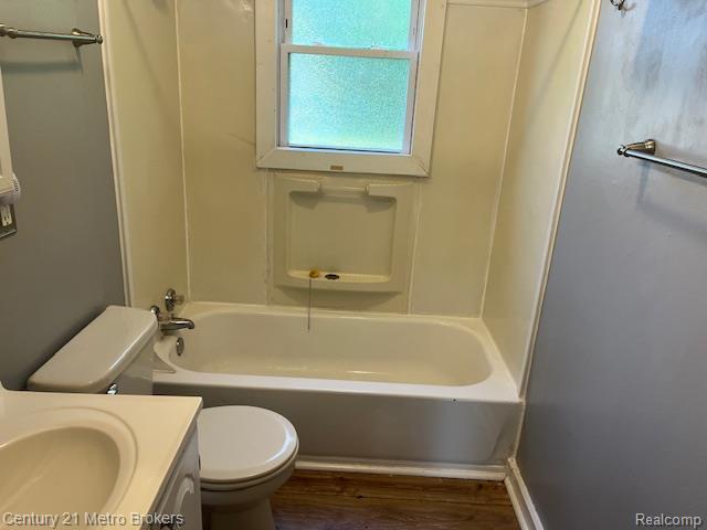 2117 E Buder Ave, Flint, MI 48529 - bathroom with vanity, wood finished floors, and bathing tub / shower combination