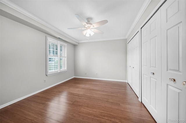 3553 Port Cove Dr Unit 39, Waterford, MI 48328 - unfurnished bedroom featuring crown molding, wood finished floors, a closet, and ceiling fan