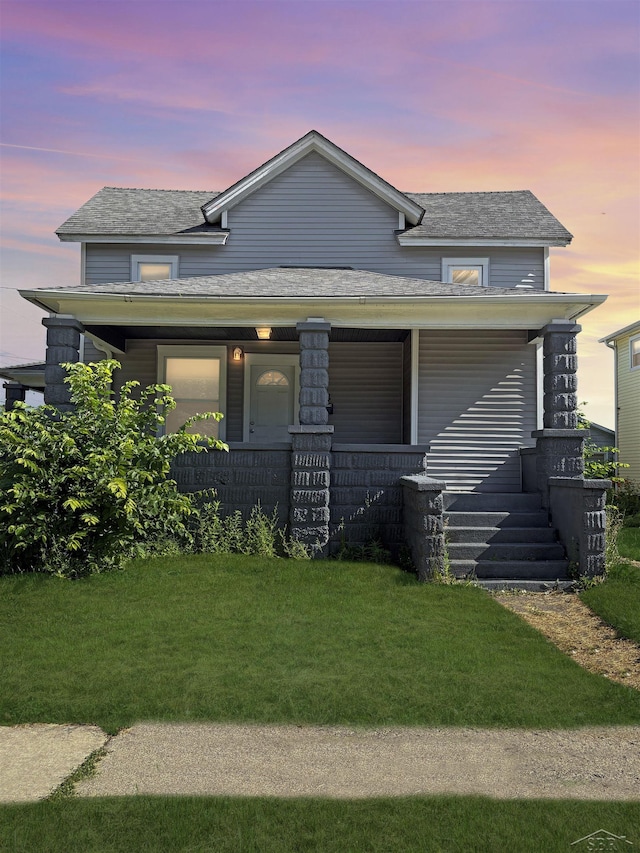2024 Cooper Ave, Saginaw, MI 48602 - view of front of house featuring covered porch, a yard, and roof with shingles