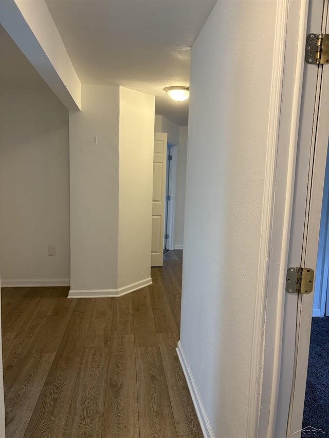 2024 Cooper Ave, Saginaw, MI 48602 - hall featuring dark wood-style flooring and baseboards