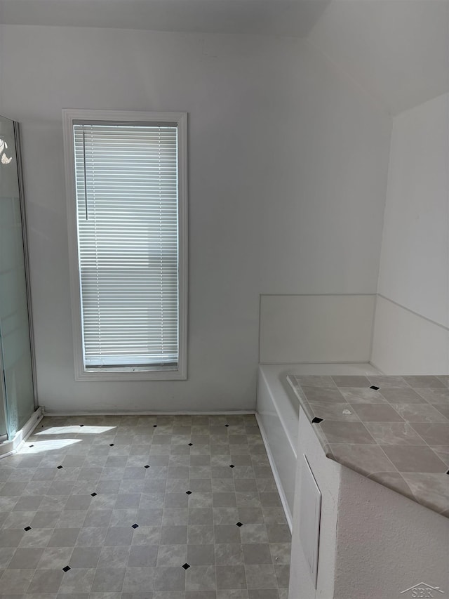 2024 Cooper Ave, Saginaw, MI 48602 - full bathroom with vaulted ceiling and a bath